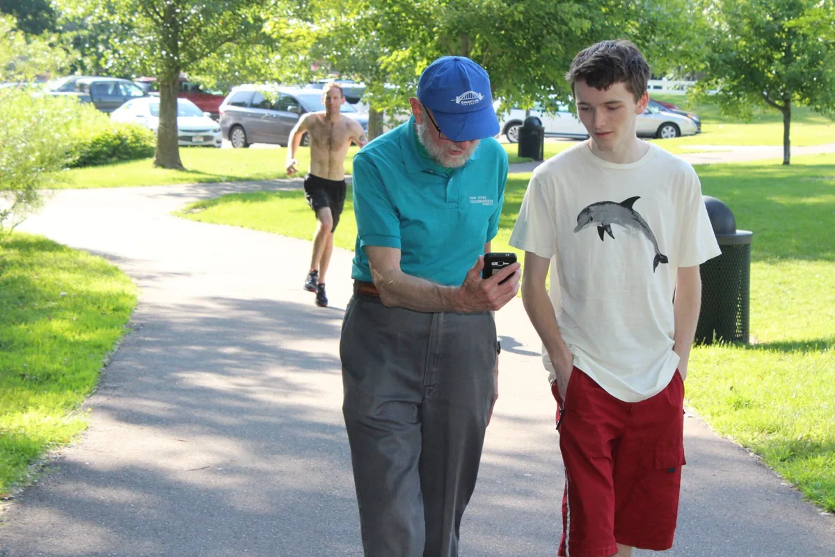Neighbors walking and talking together outdoors in Woodbury